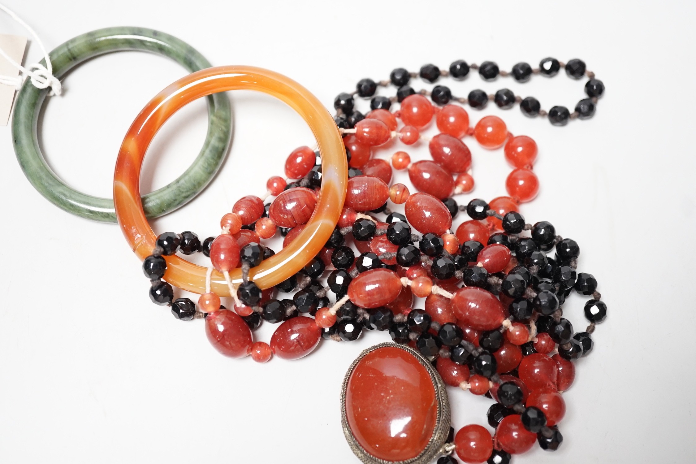 A spinach green Jade bangle and hardstone bead necklaces